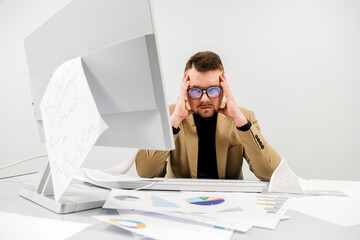 A sad businessman in an office, facing problems, stress, and mistakes with documents. The concept...