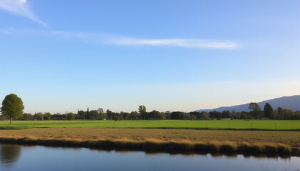 Tranquil landscape with green fields and a clear blue sky  