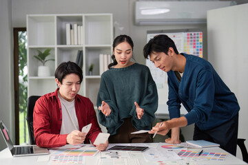 Innovative Design Solutions and Teamwork. A team evaluating UI concepts with enthusiasm in a collaborative space.