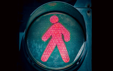 traffic light with a green man on a black background