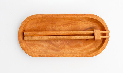 Zen Display: Wooden Stick Resting in Holder with White Backdrop