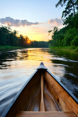 Fototapeta premium Serene sunset canoe ride on calm river