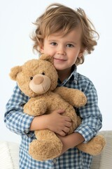 Adorable Caucasian boy with curly hair holding a teddy bear, showcasing a warm smile and a cozy atmosphere.