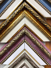 Baguette for pictures and frames, folded into a corner. Decorative wooden picture frames. Framing workshop concept. 