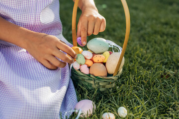 Child Collecting Colorful Easter Eggs in Green Basket