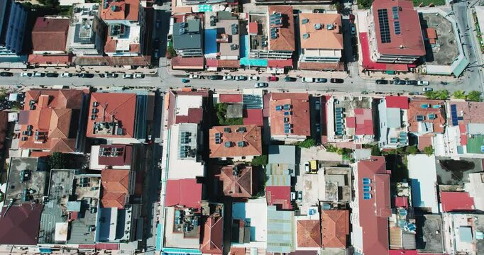 Aerial view of Paralia cityscape showcasing vibrant architecture and vibrant streets in Greece, drone shot