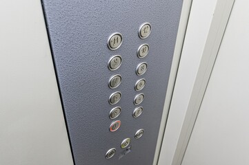 Close-up of an elevator control panel with floor buttons numbered 1-12.