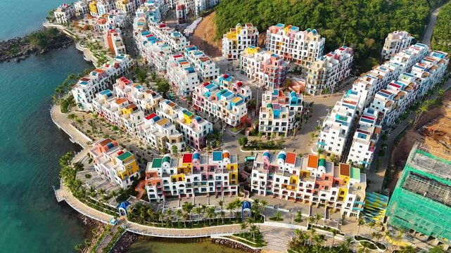 Aerial: Vinhomes fake Santorini construction site during the day in Sunset Town, Phu Quoc Island, Vietnam, orbit drone shot