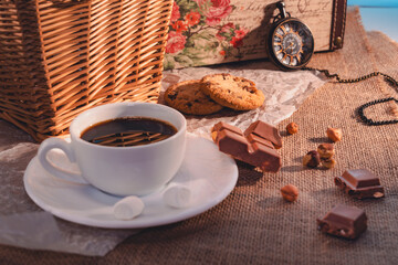 Vintage still life with coffee, chocolate, cookies, and pocket watch