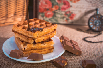 Waffles with dripping chocolate, chocolate pieces, and pocket watch