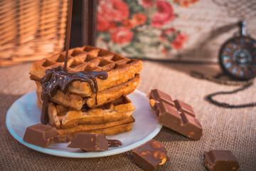 Waffles with dripping chocolate, chocolate pieces, and pocket watch