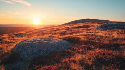 Naklejka premium Sunset over autumnal mountain landscape, rocks and grasses