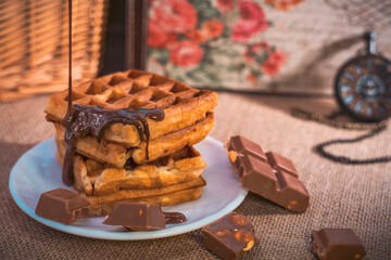 Waffles with dripping chocolate, chocolate pieces, and pocket watch