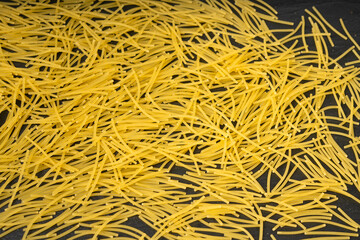 Raw vermicelli textured background, gold soup pasta pattern, small homemade noodles mock up