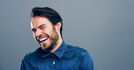 Laughing, joke and face of man in studio for comic, funny and silly with mockup space. Happiness,...