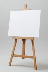 A white canvas is propped up on a wooden easel. The canvas is empty, and the easel is standing upright. Concept of simplicity and minimalism, as the focus is on the blank canvas