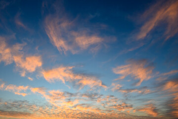 Evening sky paints a beautiful tapestry of clouds reflecting soft hues during golden hour