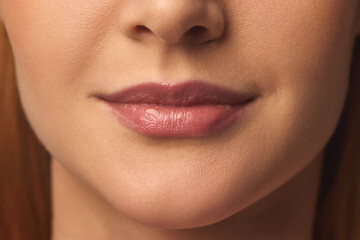 Naklejka premium Detailed close-up of full, well-hydrated lips, soft natural gloss, smooth skin texture enhancing feminine beauty. Concept of skincare, lip care, wellness, aesthetics, cosmetics, dermatology, self-love