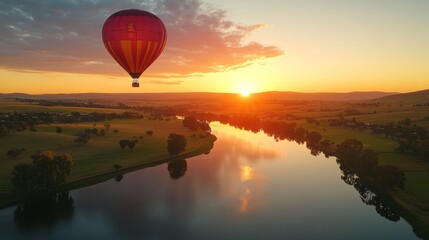Sunrise hot air balloon over river valley