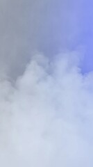 Fototapeta premium A soft blend of white and blue smoke fills the frame, creating a dreamy and ethereal atmosphere.