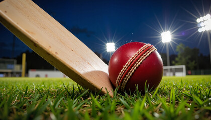 Cricket ball colliding with bat under stadium lights, sporting intensity