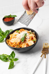 men's hands grate parmesan into paste