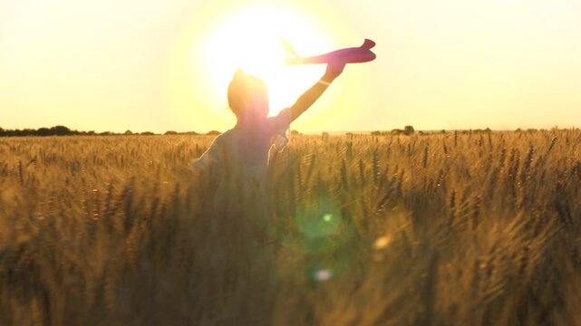 little child girl daughter runs through wheat field with toy plane her hand sunset, happy family dream fly, child airplane runs through wheat field his hand, wants become astronaut, child wants become