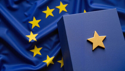 Golden star emblem on dark blue paper with blurred European flags for Europe Day celebration