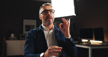 Mature man, discussion or interview with talk for online tutorial or development process. Male...