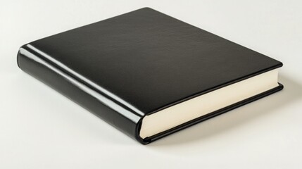 Elegant black leather-bound book with cream-colored pages rests on a white surface. A sophisticated and minimalist image.