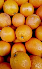 Close up of a display of oranges.