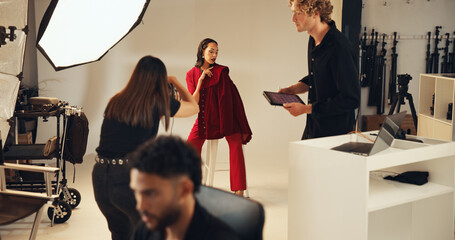 Photoshoot, photographer and model in studio, creative and pictures for fashion magazine or production. Backstage, people and group with project for media agency, camera and equipment for photography