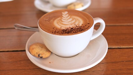 Savoring smooth cappuccino with velvety foam Warm beverage rich coffee notes and gentle cafe ambiance create refined experience blending indulgence with perfect coffee moment Coffee theme concept