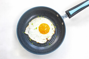 fried egg in a frying pan isolated on white background