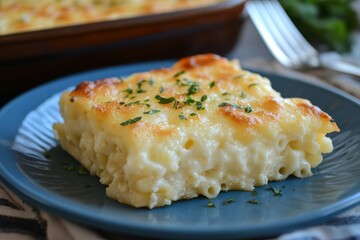 Creamy baked macaroni and cheese served on a blue plate with fresh garnishes at a cozy kitchen table