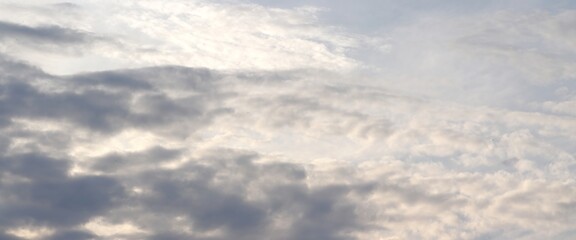 A close-up of the cloudy sky. Color background. Soft shapes. Simple composition. Abstract environment. Atmosphere of presence. Picture. Wallpaper. Poster. Postcard. Place to insert