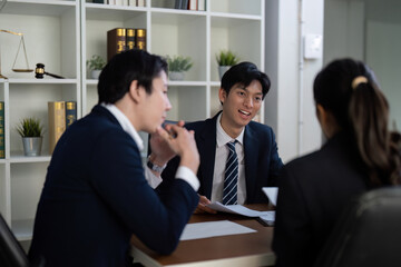 Engagement and Legal Strategy. Lawyers collaborating on a case discussion.