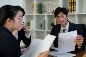Documentation and Legal Insight. Lawyers reviewing important case files together.