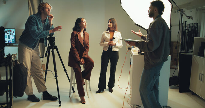 Makeup artist, model and photographer in studio for discussion, photoshoot or planning together. Backstage, creative or media with photography people talking on set for collaboration or production