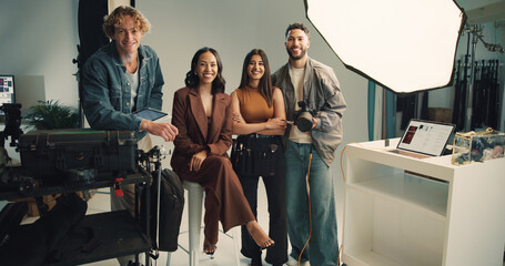 Production, portrait and smile with people in studio together for collaboration, editing or photoshoot. Backstage, creative or media with makeup artist, model and photographer on set for filming