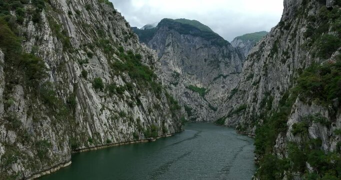 Komani Lake Surrounded By Towering Mountains Of The Albanian Alps In Kukes, Albania. drone pullback shot