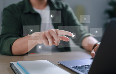 Naklejka premium E-learning concept, online seminar, internet education, businessman is touching the virtual screen with his hand to watch the video.