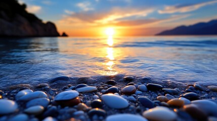 Naklejka premium Coastal sunset over calm waters. Pebbles on the shore