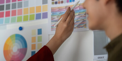 Creative Ideation and Color Selection. Team member selects colors from a comprehensive palette for a project.