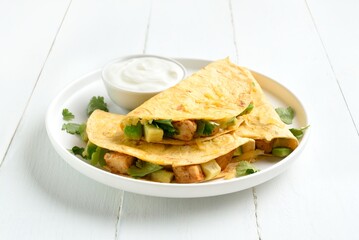 Chicken avocado quesadillas served with sauce
