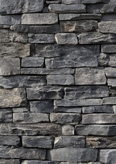 Fototapeta premium Gray stone wall exterior cladding, close-up view of stacked stones, modern architecture