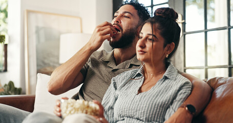 Movie, popcorn and couple watching tv on sofa in home with subscription service for bonding. Love, connection and man with woman for streaming film, show or series for entertainment on date in house.