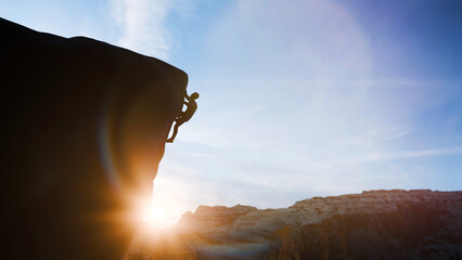 Climber ascending a steep rock face during sunset, demonstrating perseverance and strength in extreme sports