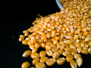 corn kernels spill from a bowl