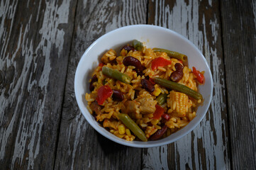 Colorful rice dish brimming with vegetables and beans evokes a sense of comfort and warmth on a...
